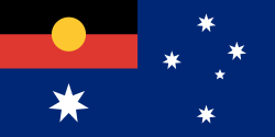 A speculative Australia flag worn by Australian actor Sam Neill in the movie Event Horizon. It combines the Aboriginal Flag with the current Australian Flag. Image courtesy of Wikimedia Commons. Public Domain.